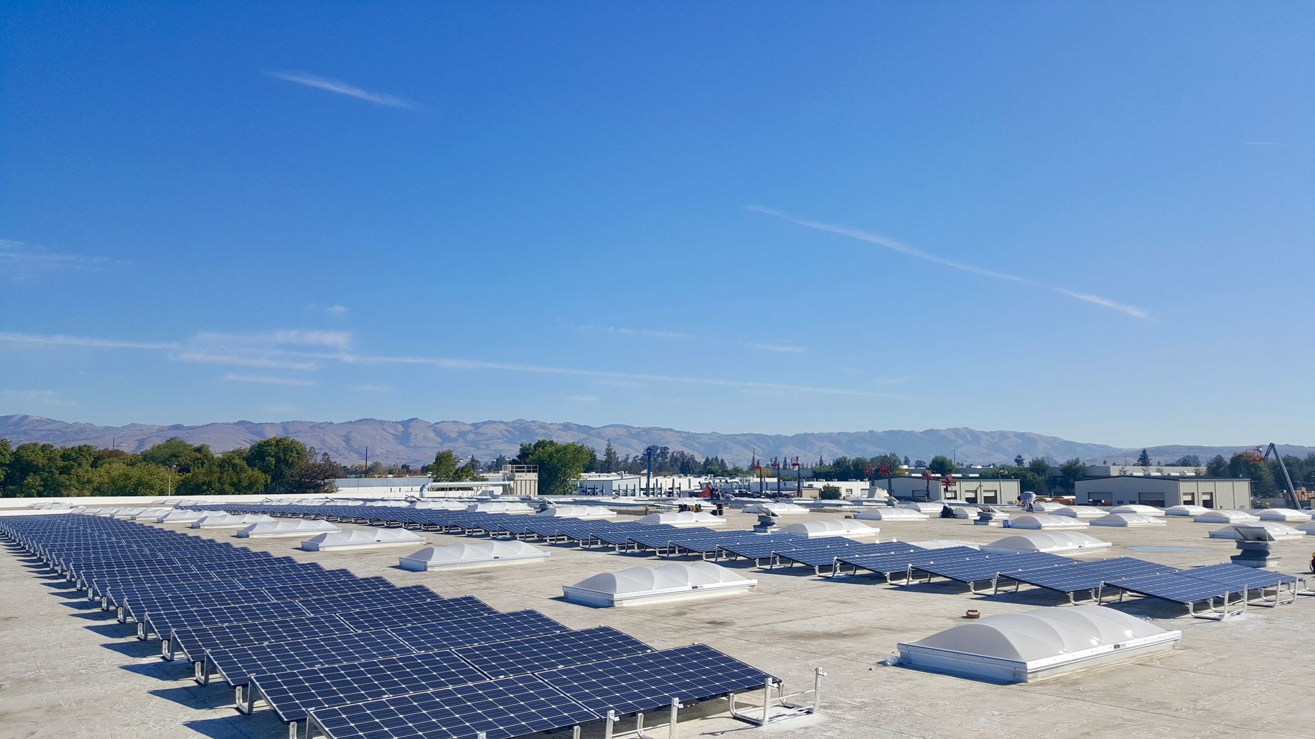 A row of solar panels on the roof of a building