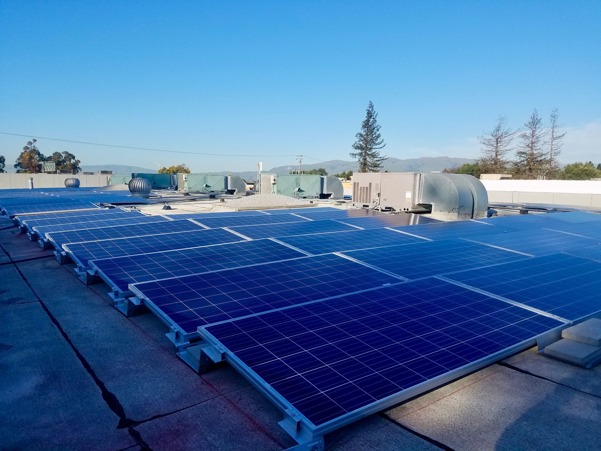 A row of solar panels on the roof of a building