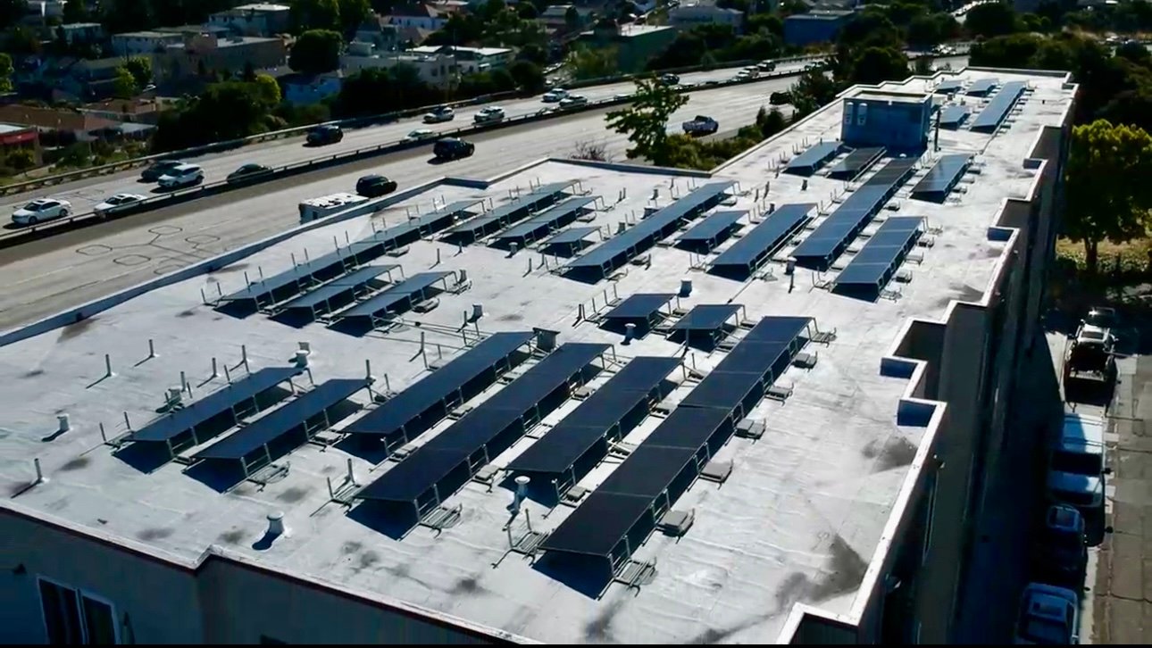 An aerial view of a building with solar panels on the roof