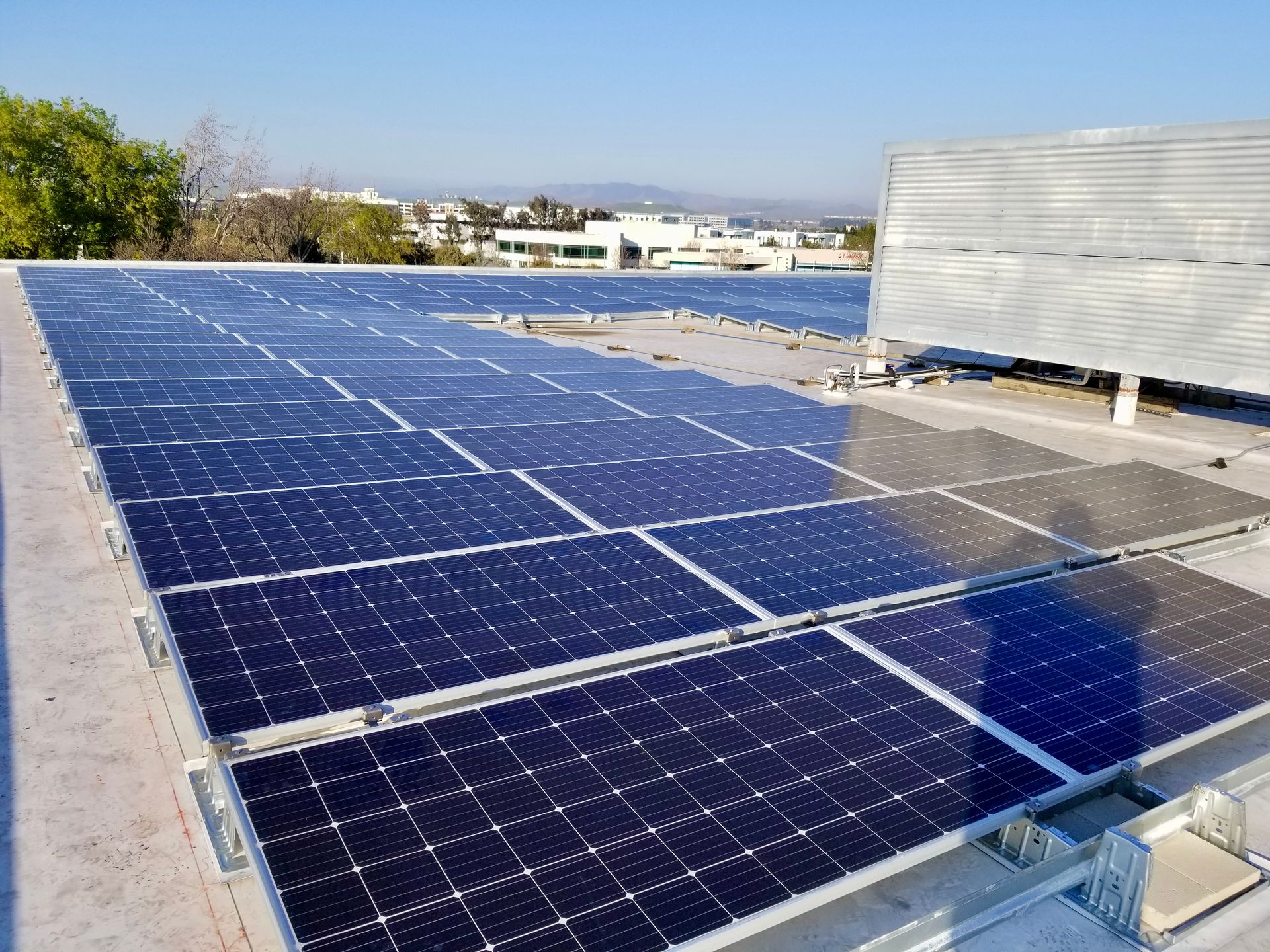 A row of solar panels on the roof of a building