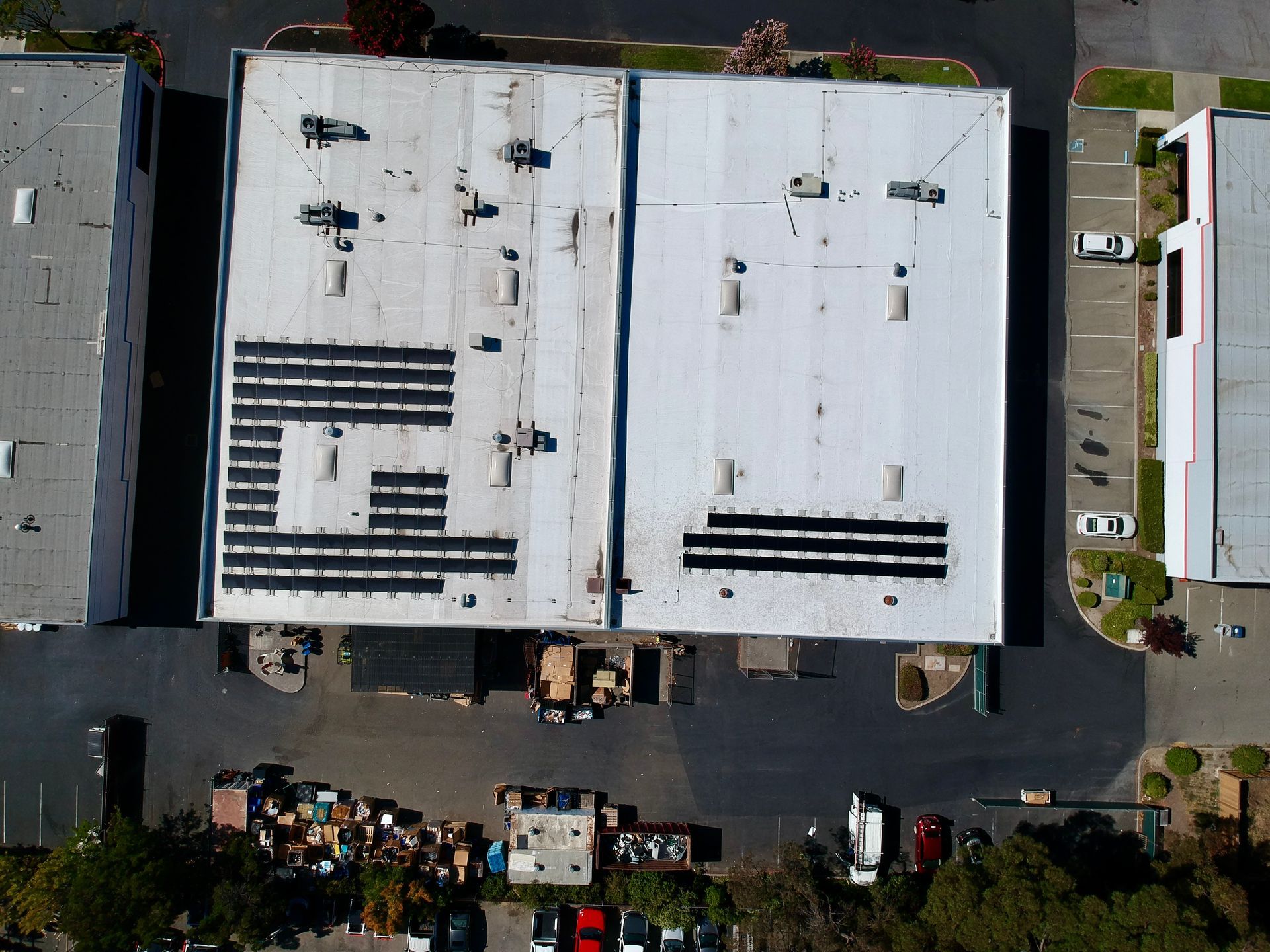 An aerial view of a building with solar panels on the roof