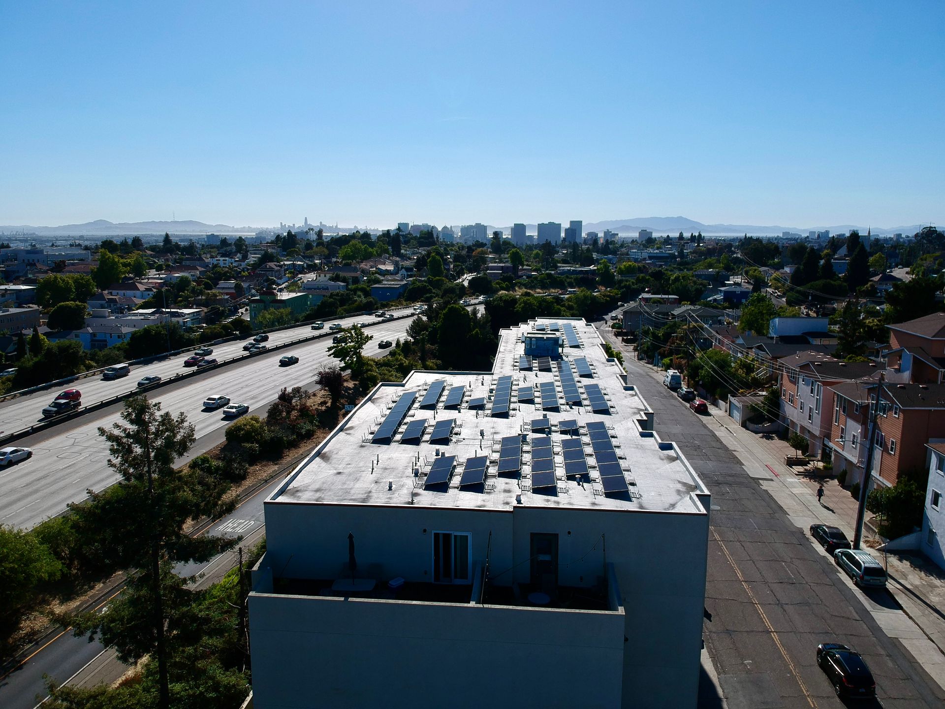An aerial view of a building with solar panels on the roof