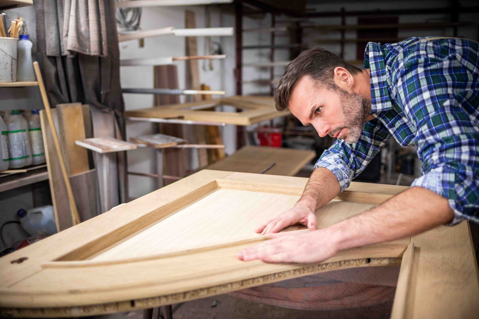A man building a section for a closet system for a customer before bringing it to the site for installation.