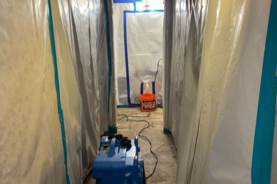 Professional asbestos removal in a residential home during water damage restoration