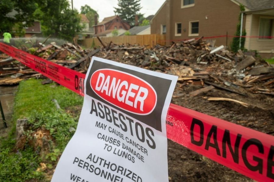 Professional asbestos abatement warning signage at work area