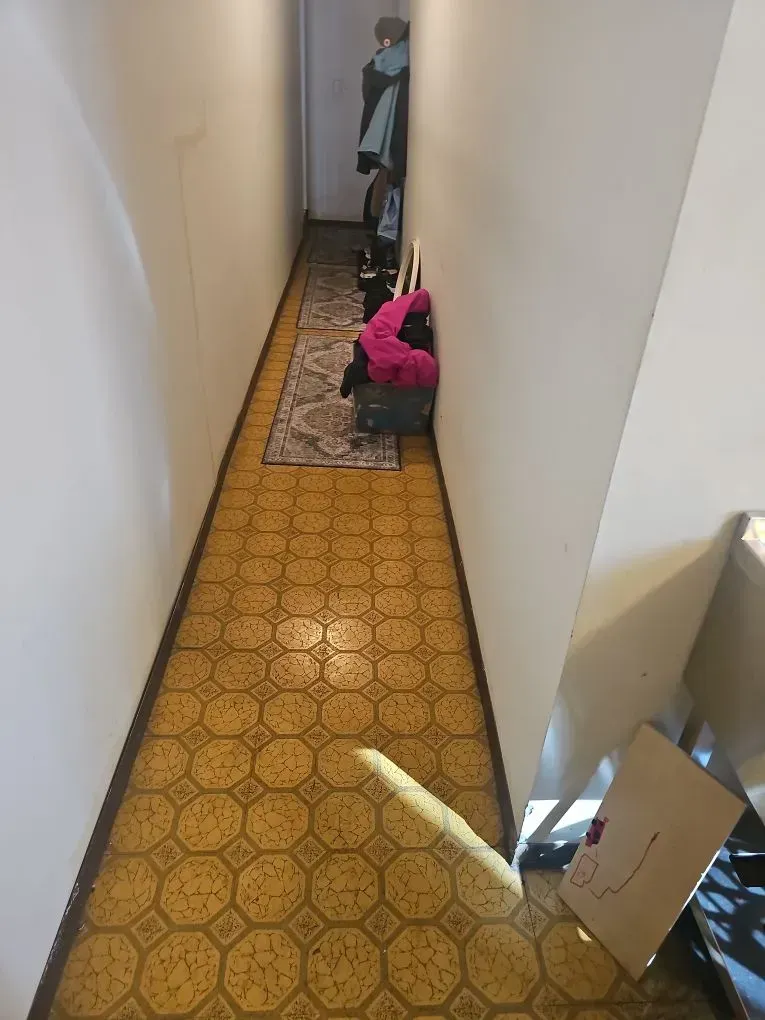 Asbestos-containing material in laundry room showing extent of ACM presence