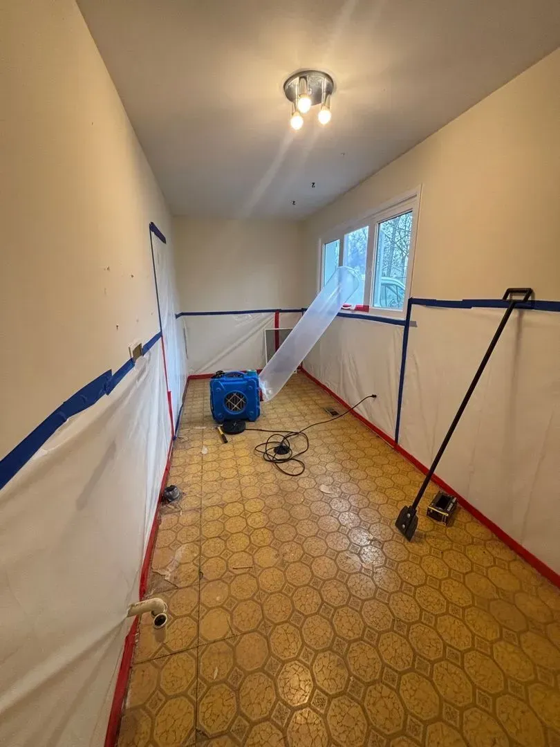 Asbestos removal in progress with full containment protocol in place
