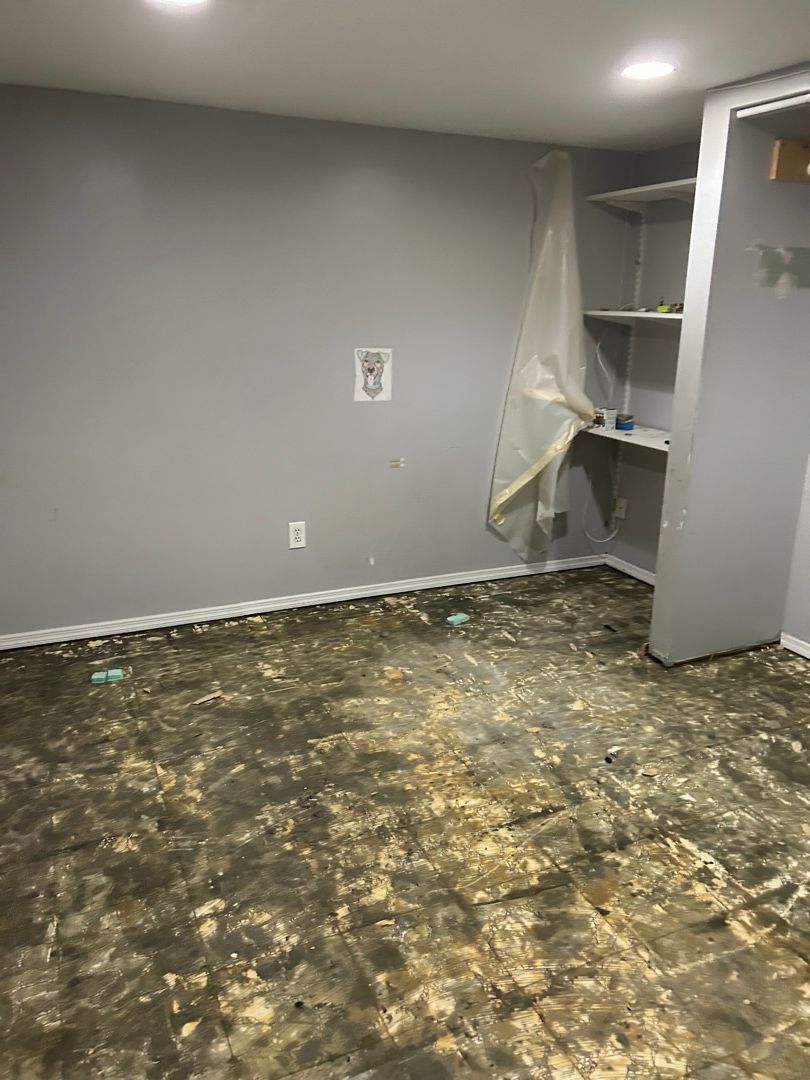 Basement bedroom after pack-out showing cleared space ready for drywall and flooring replacement