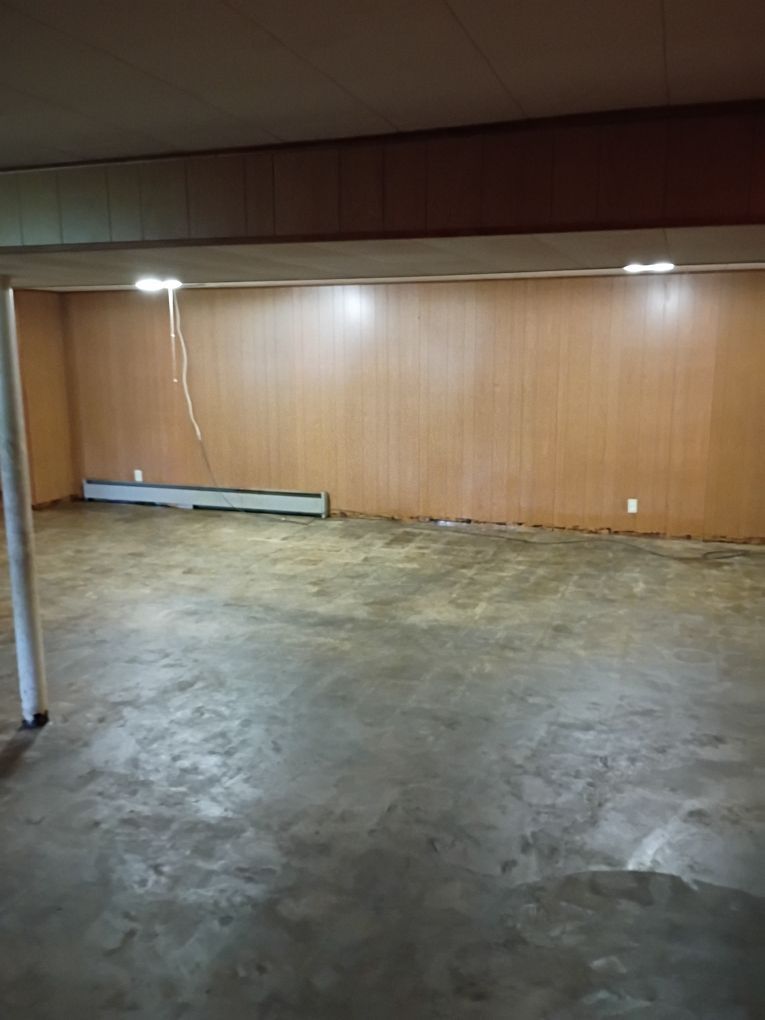 Safe, dry basement ready for rebuild after mitigation and asbestos removal