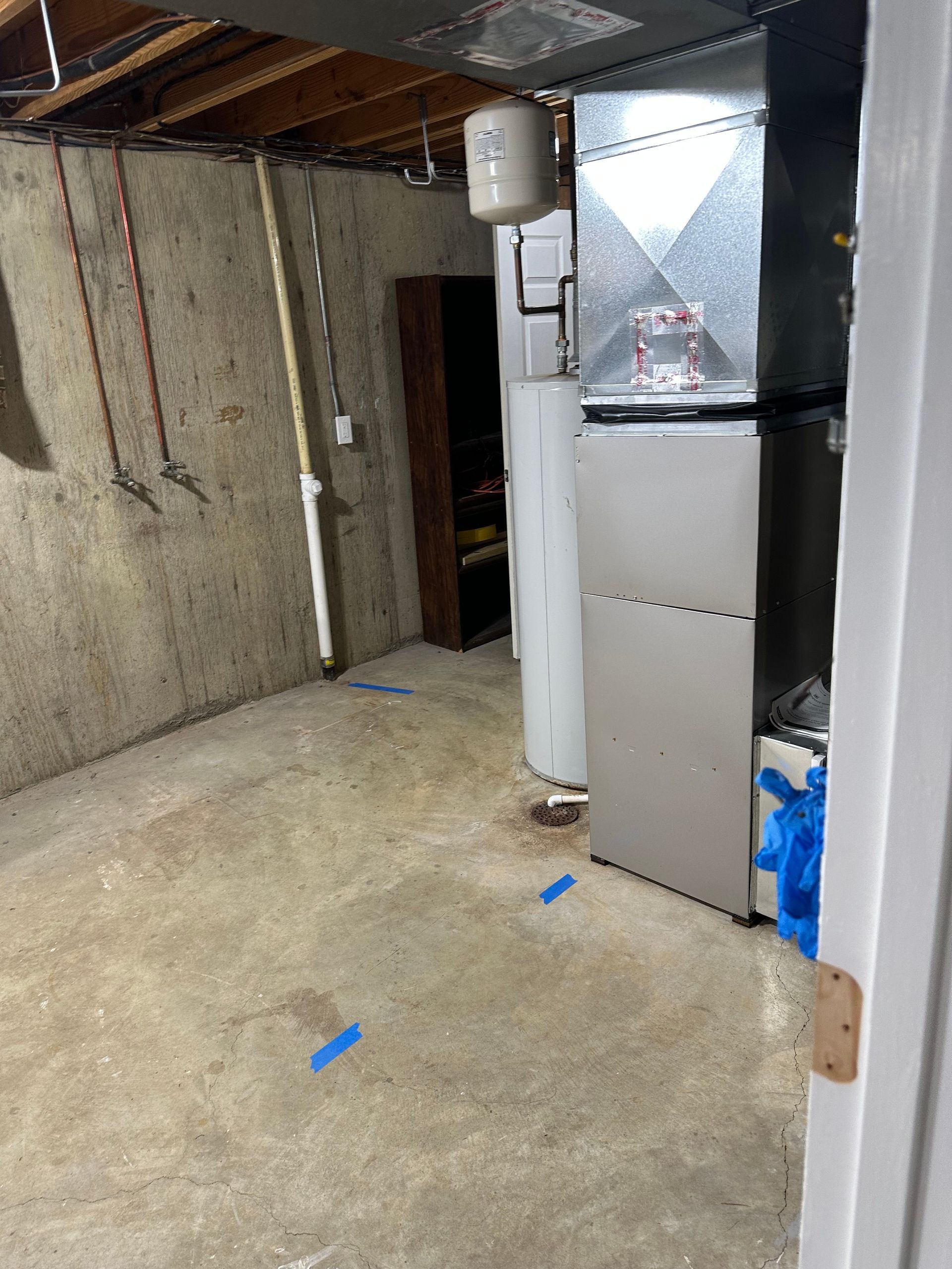 Utility room cleanup near furnace and water heater after flooding