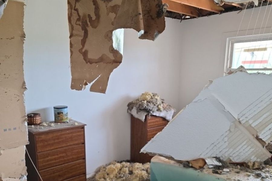 Collapsed ceiling inside a home caused by storm water intrusion