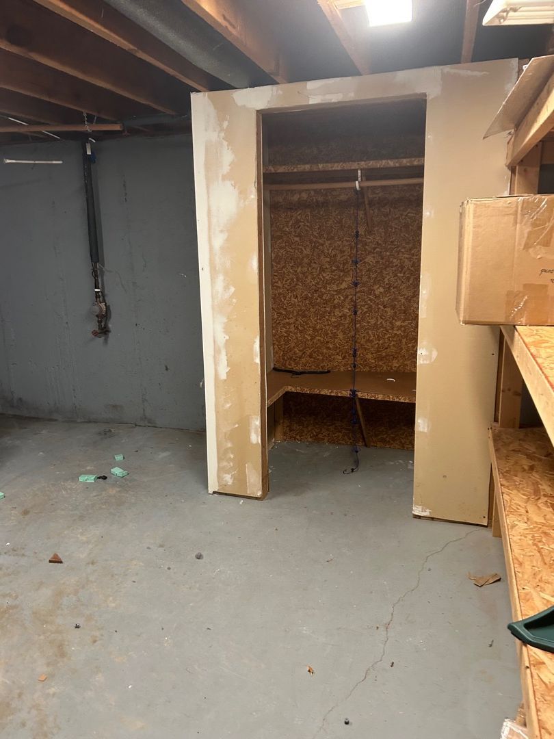 Empty basement room after a complete contents pack-out showing cleared space ready for restoration