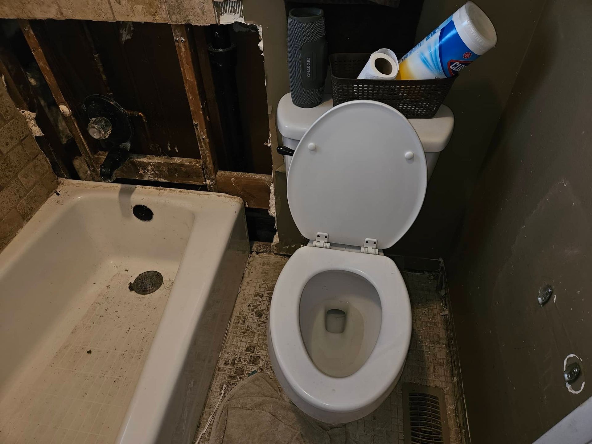 Flood cut drywall removed around the bathtub and toilet to dry the wall cavity