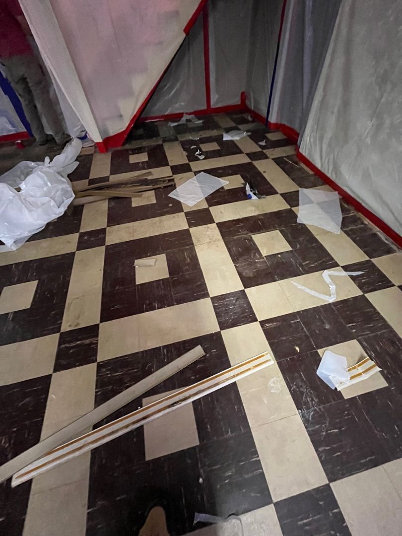 Sealed containment set up in a basement after water damage with asbestos present