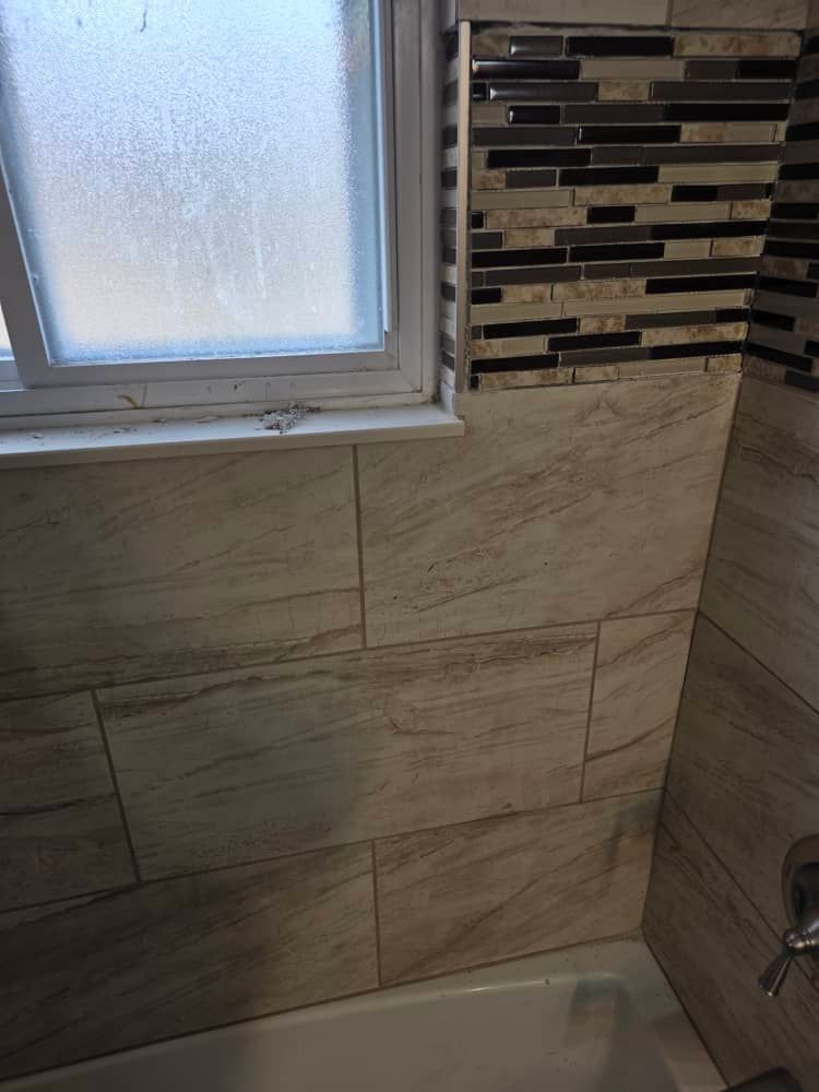 Finished tile work in the repaired water-damaged bathroom