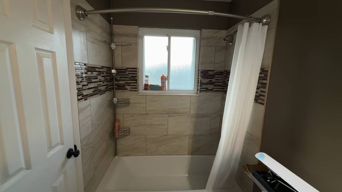 Fully repaired and finished residential bathroom after water damage restoration
