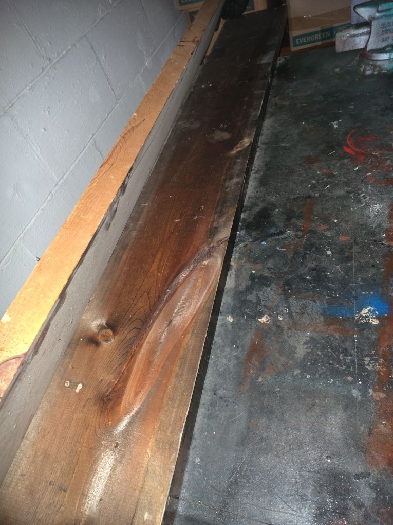 Smoke and soot residue covering walls and surfaces in fire-damaged basement room