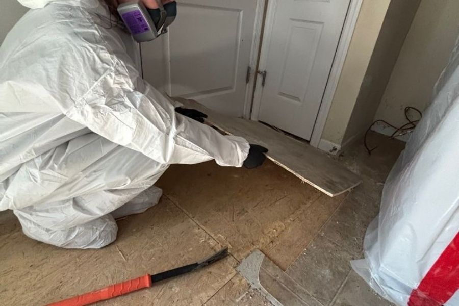 Damaged flooring being removed during reconstruction prep after a residential fire