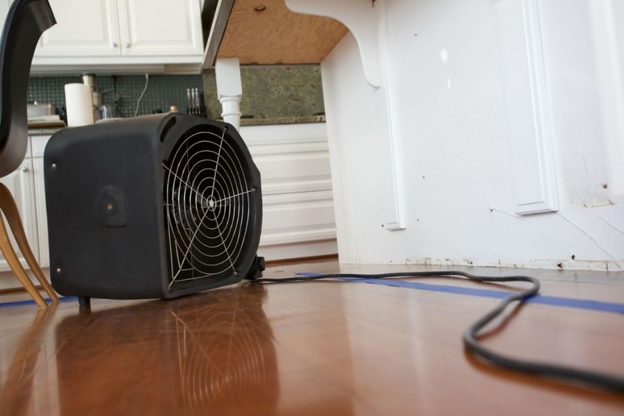 Industrial drying equipment on kitchen floor after water damage