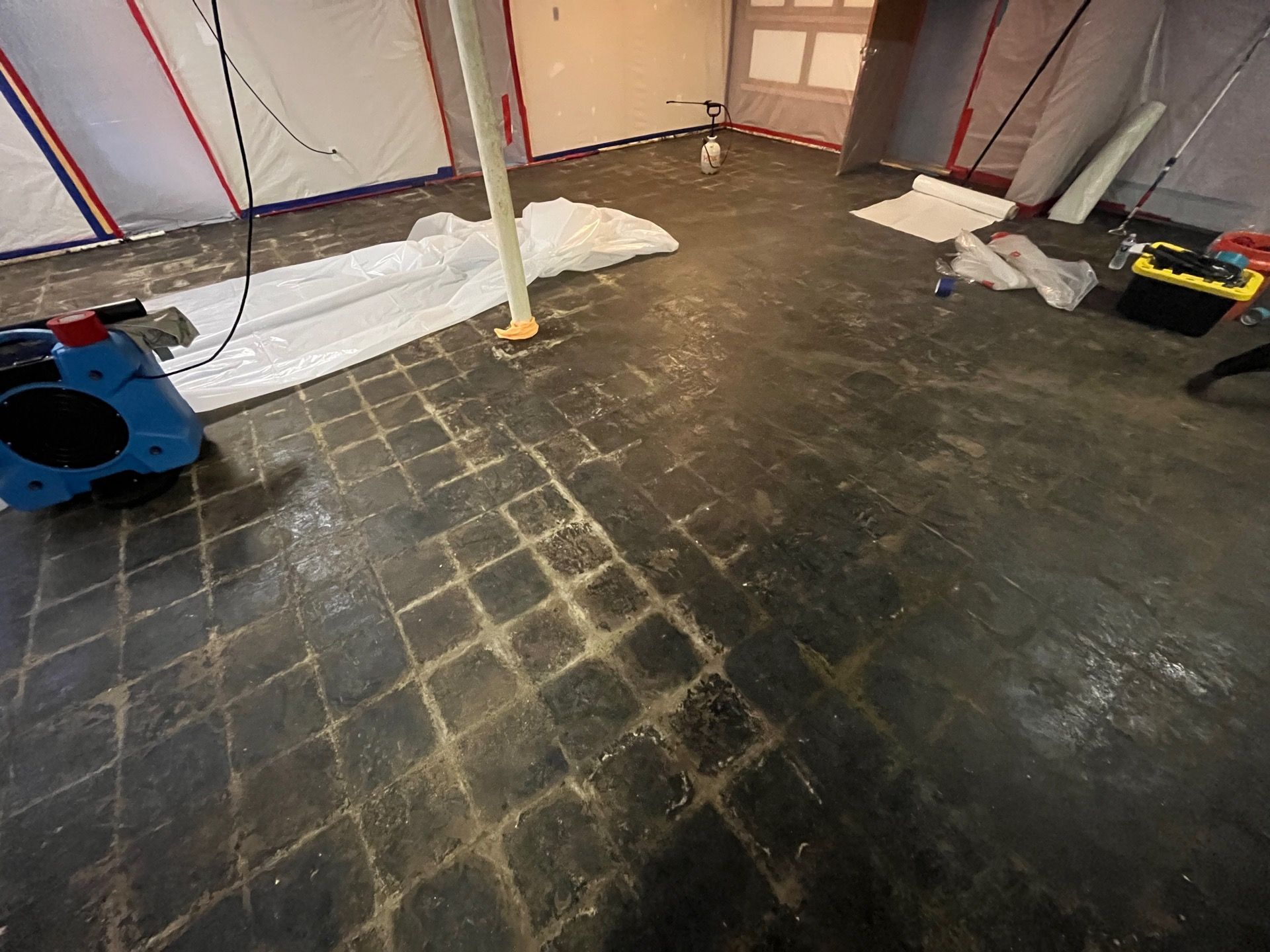 Crew performing professional asbestos removal in a Florissant basement