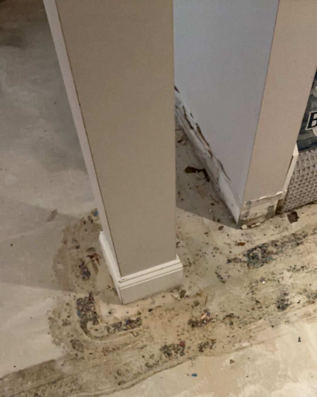 Damaged baseboard and drywall requiring removal