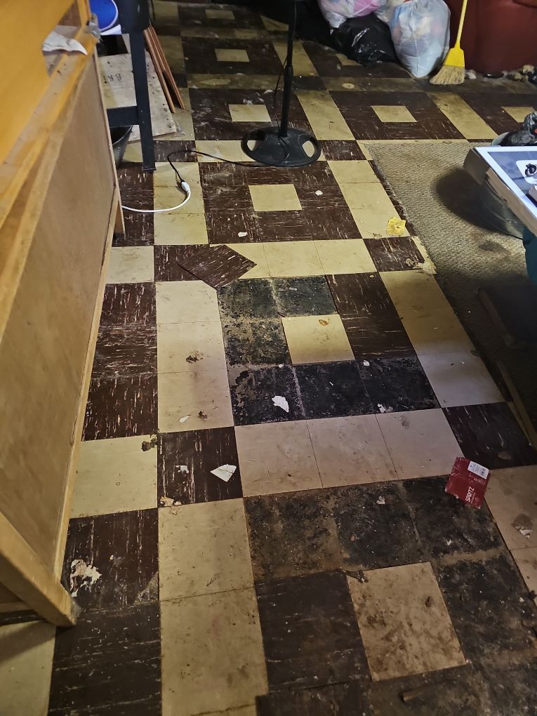 Standing moisture and water staining in a water-damaged basement