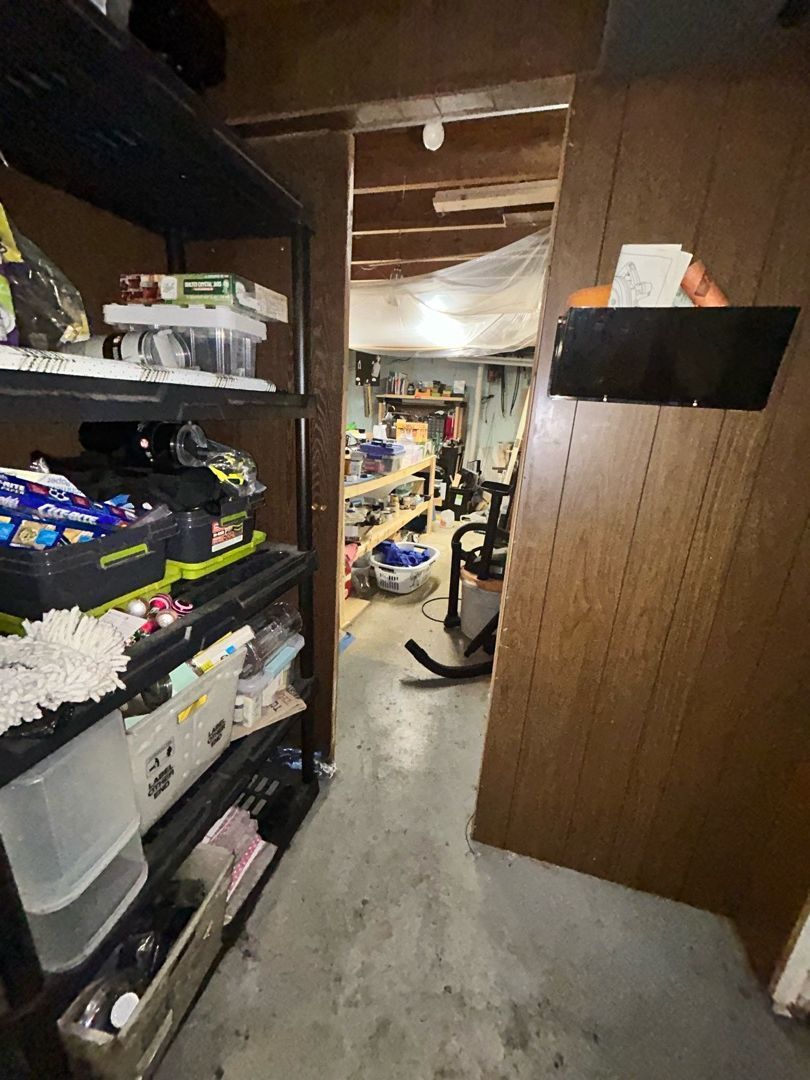 Water damage visible on basement floors and walls in a Florissant home