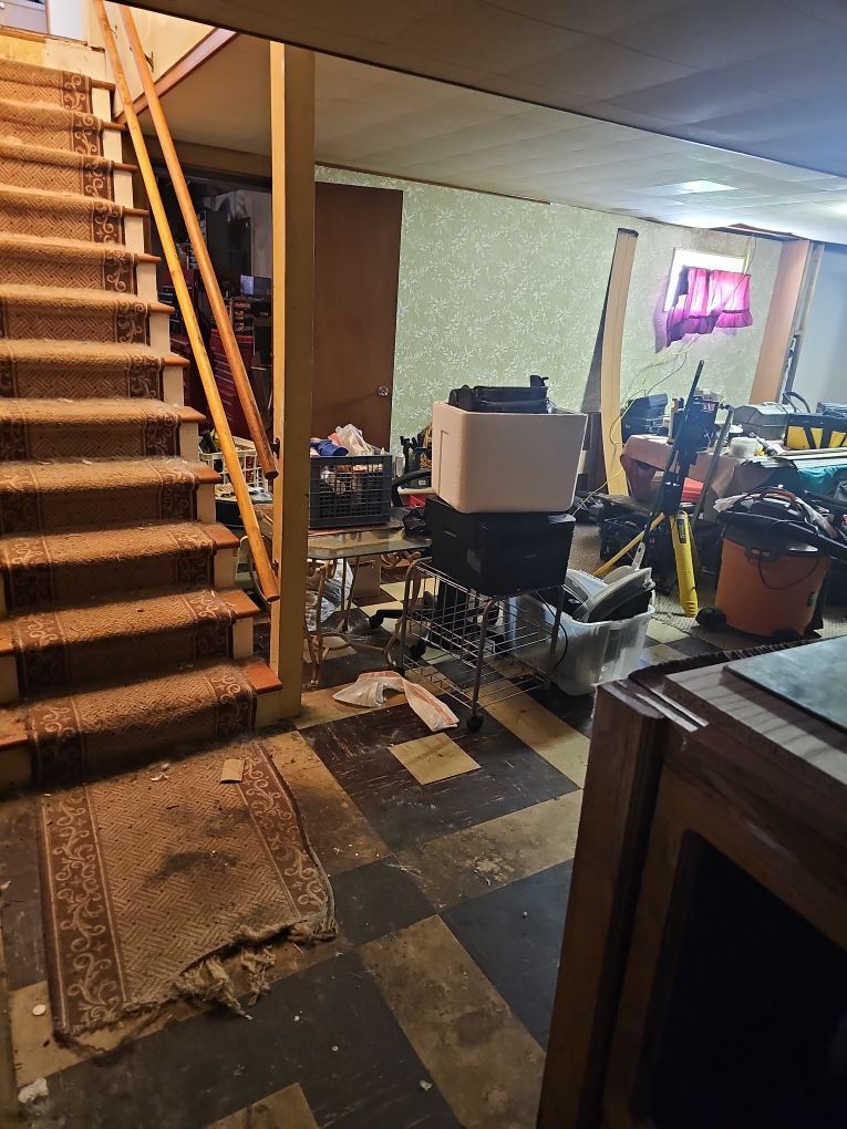 Water-damaged basement showing saturated materials before cleanup