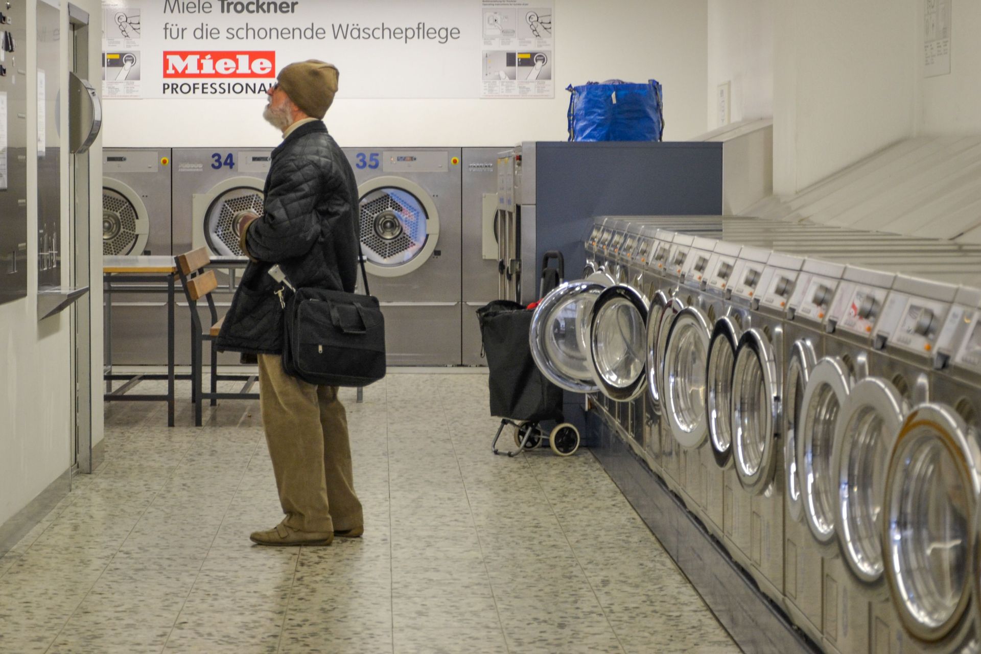 Technician repairing a washing machine drum in a laundry room