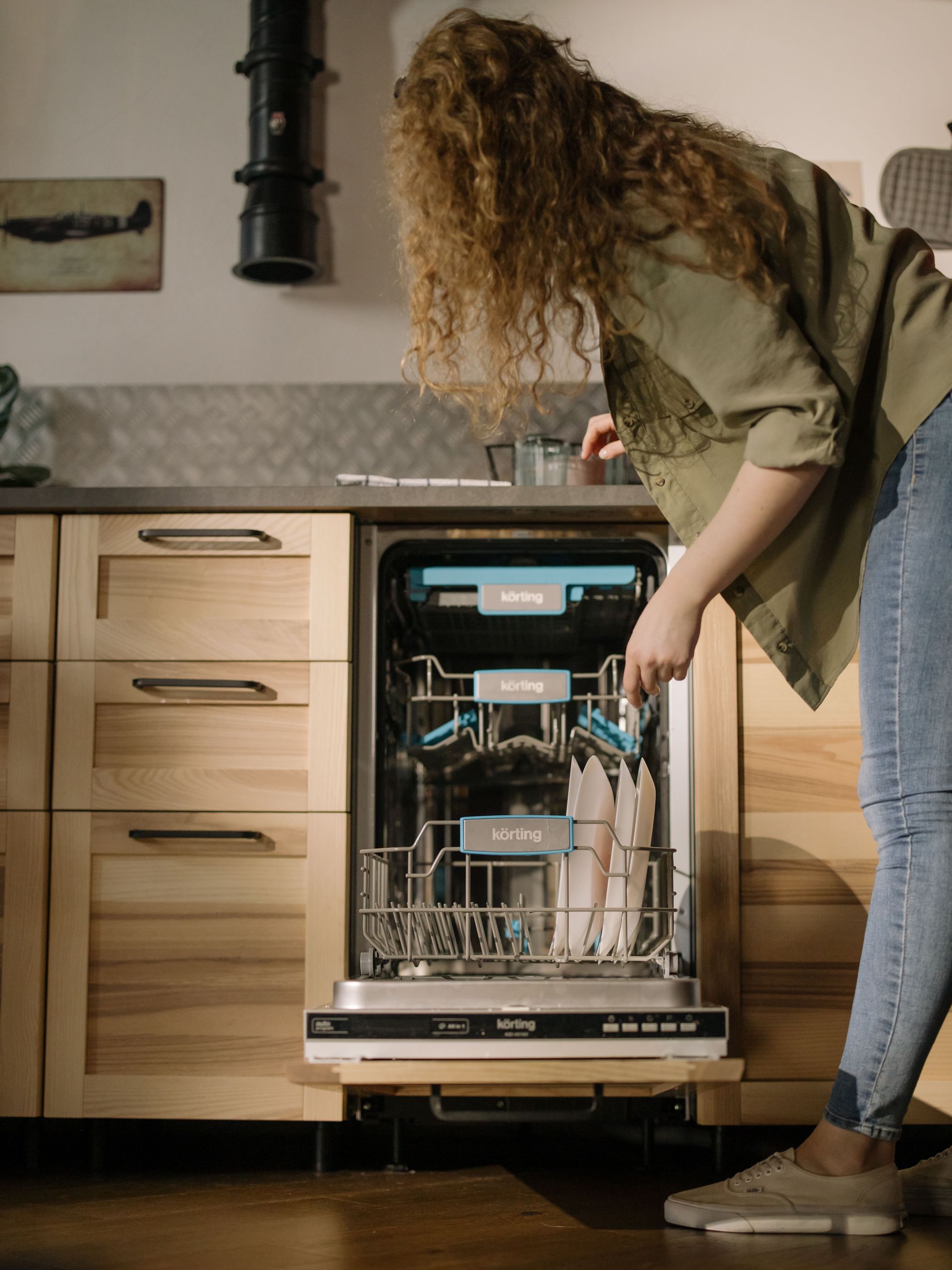 Man inspecting an open oven in a modern kitchen