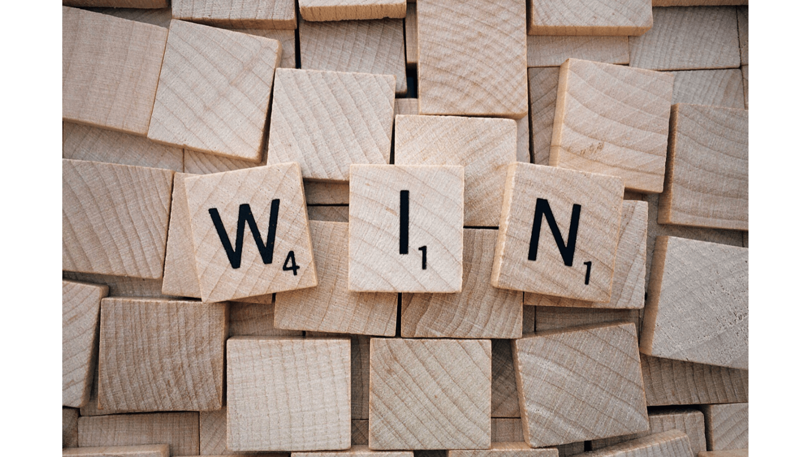 wooden scrabble tiles with a text win write on it
