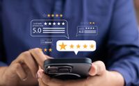 Person holding a smartphone with floating star rating reviews on screen