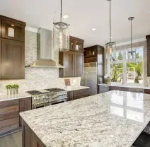Modern kitchen with dark wood cabinets, white granite island, and stainless steel appliances
