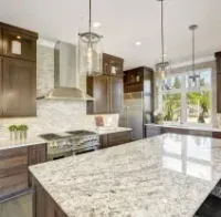 Modern kitchen with dark wood cabinets, white granite island, and stainless steel appliances