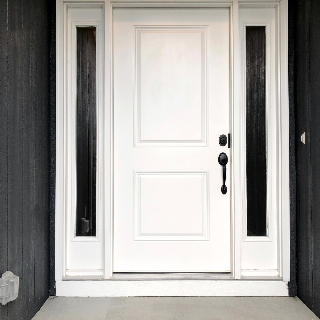 White front door of home with two side windows.