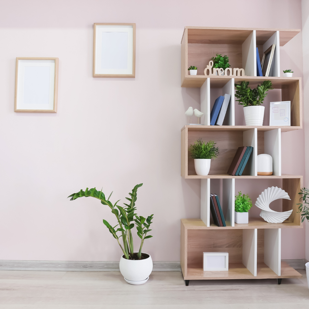 Shelving system with books, plants and sculptures in a Vermont home.