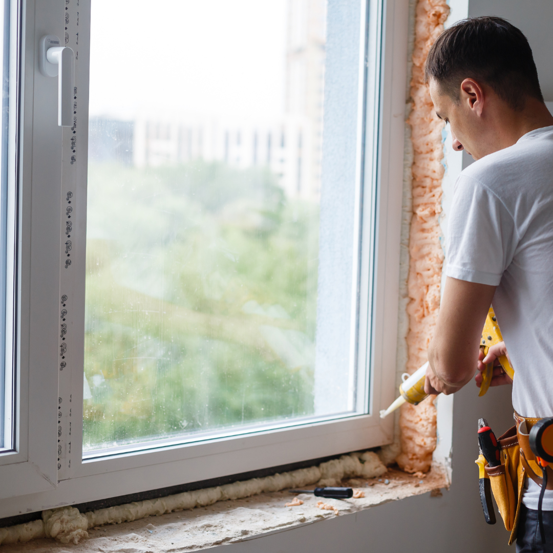 Someone installing new windows in a home.