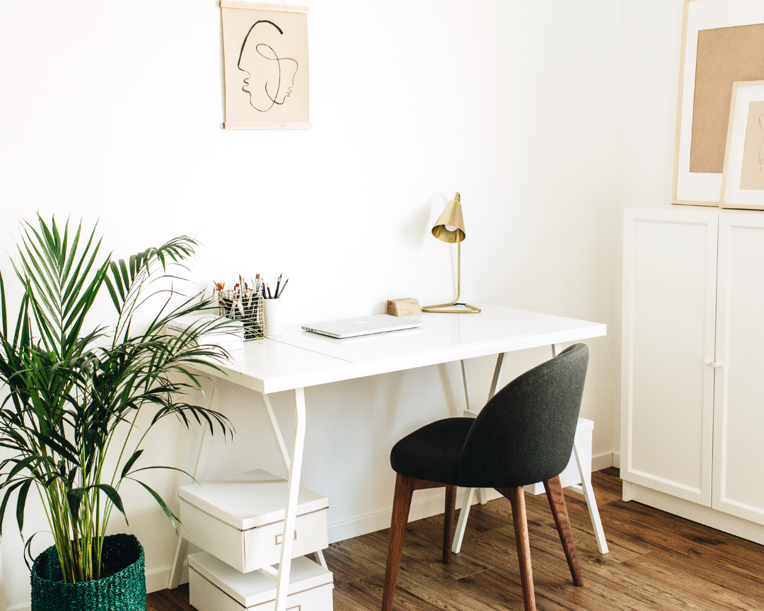 Home office space with white desk and gray chair.