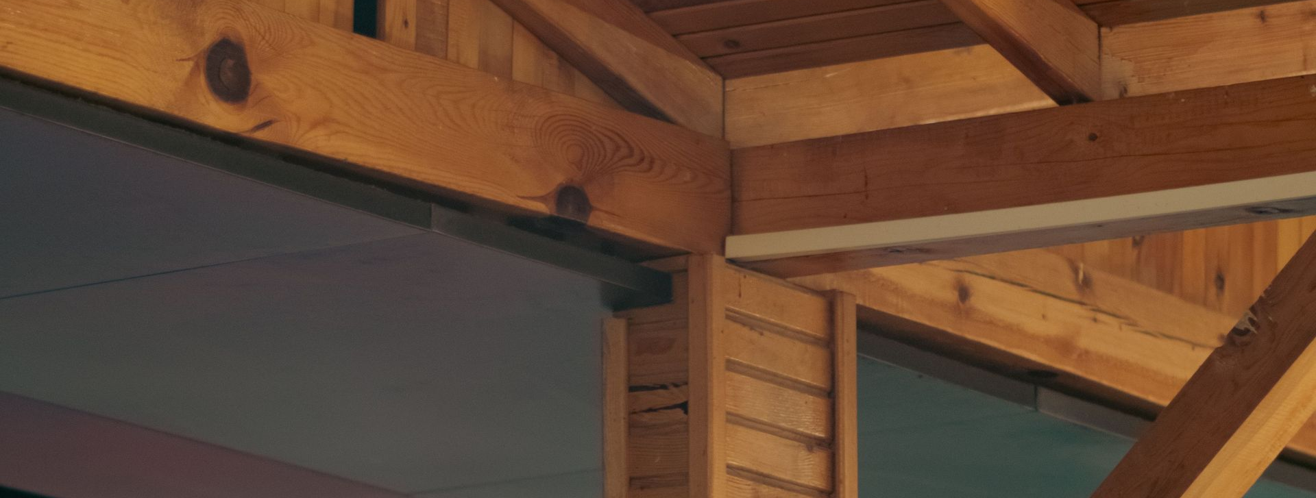 Exposed wood beams and timber framing in a Vermont post-and-beam home.