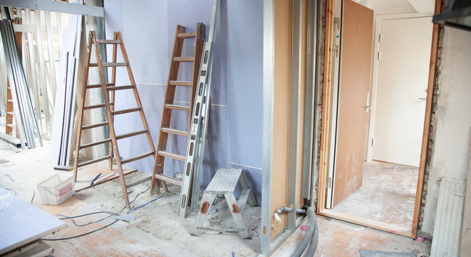 A room under construction with a ladder on the floor