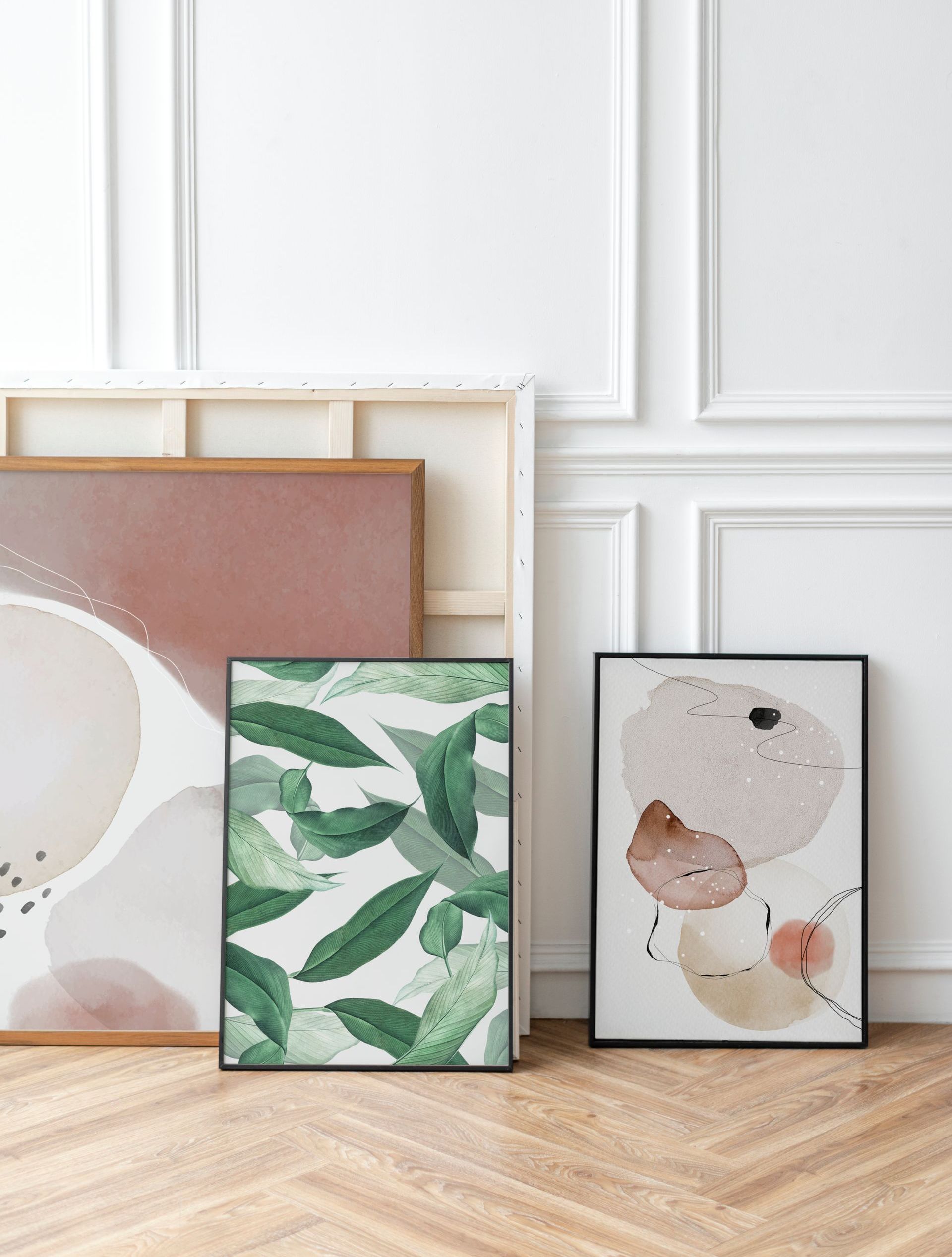 Several modern and abstract art pieces ready to be hung on a wall