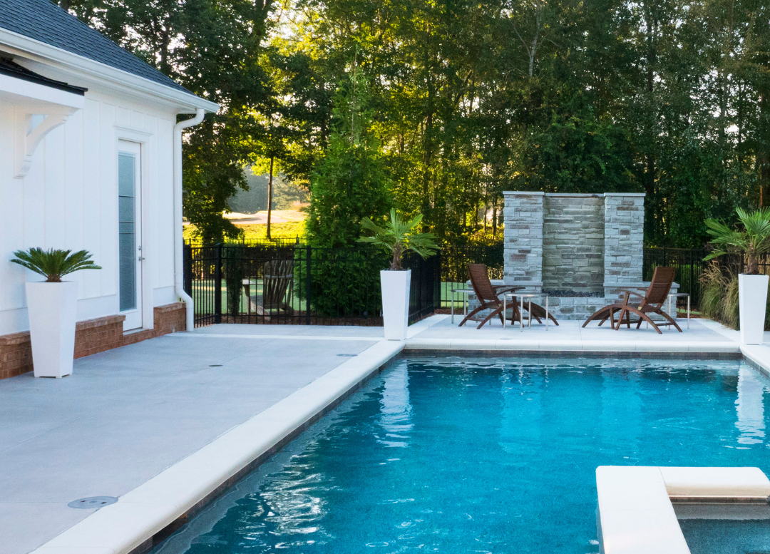 Outdoor pool in the backyard of a house.