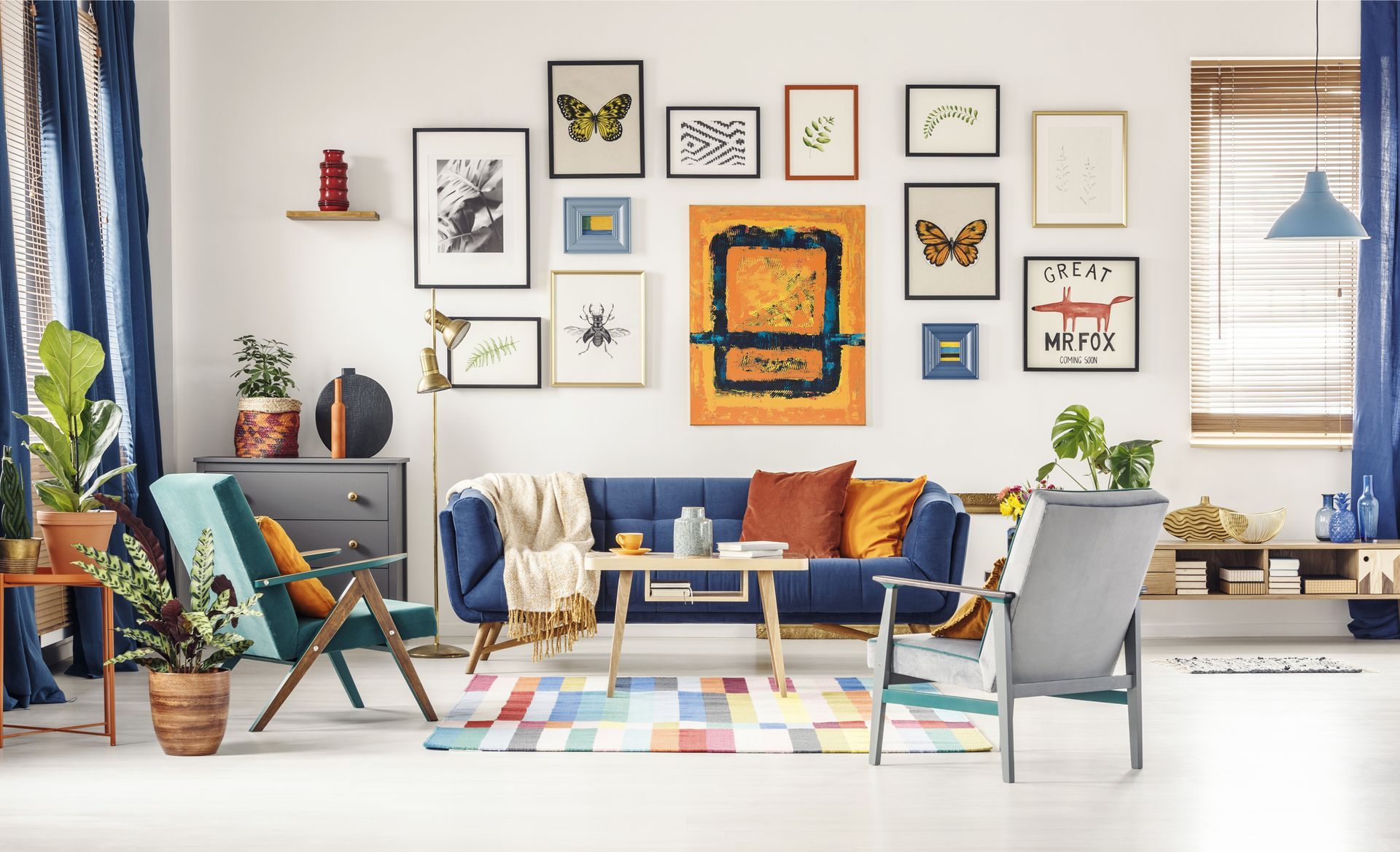 A white room with bright accent colors and a gallery wall