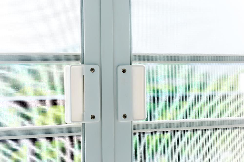 A Close up Of a Sliding Glass Door with A White Handle — Grafton Glass in South Grafton, NSW