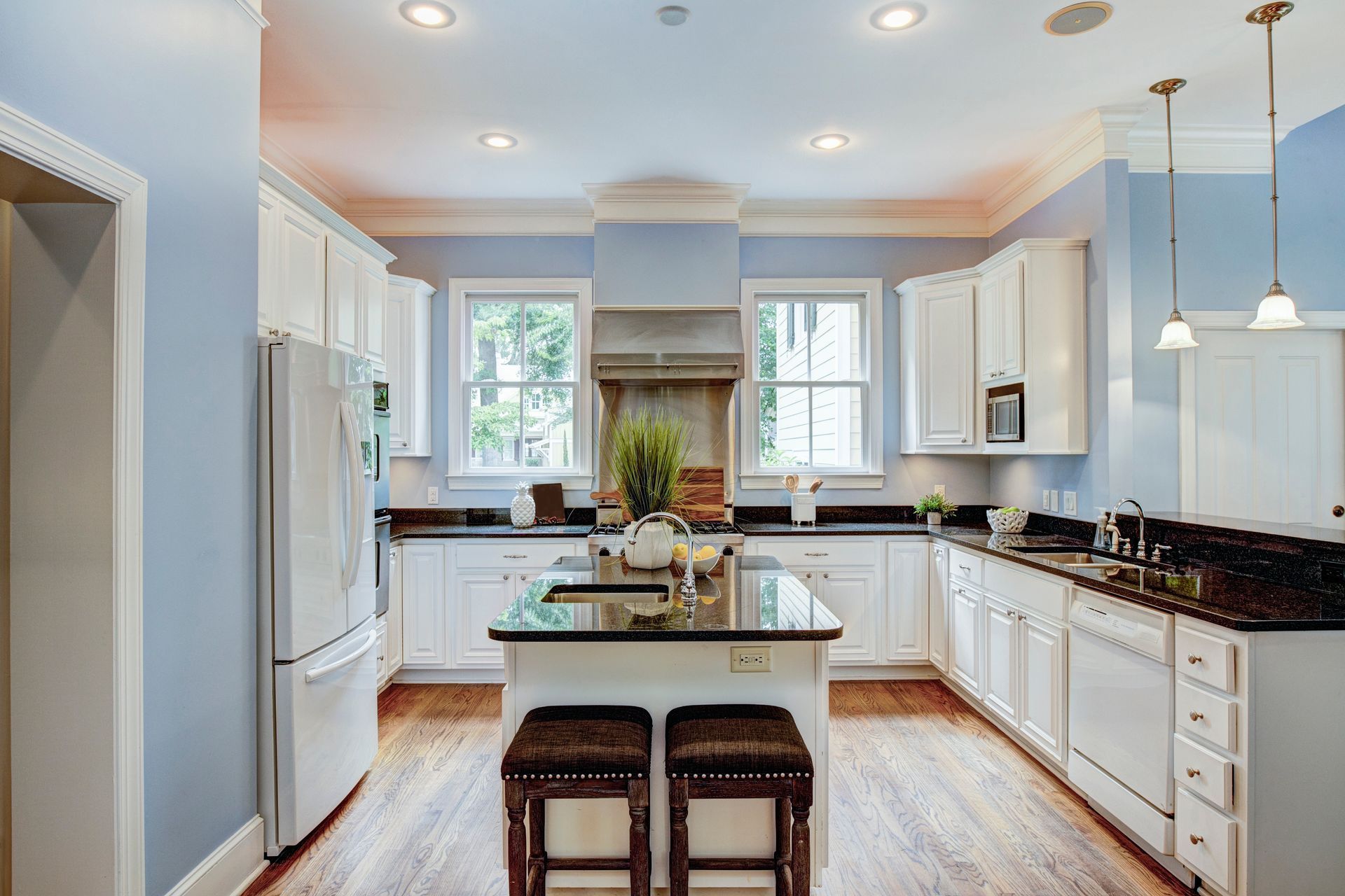 Large American-style kitchen interior with granite countertops.