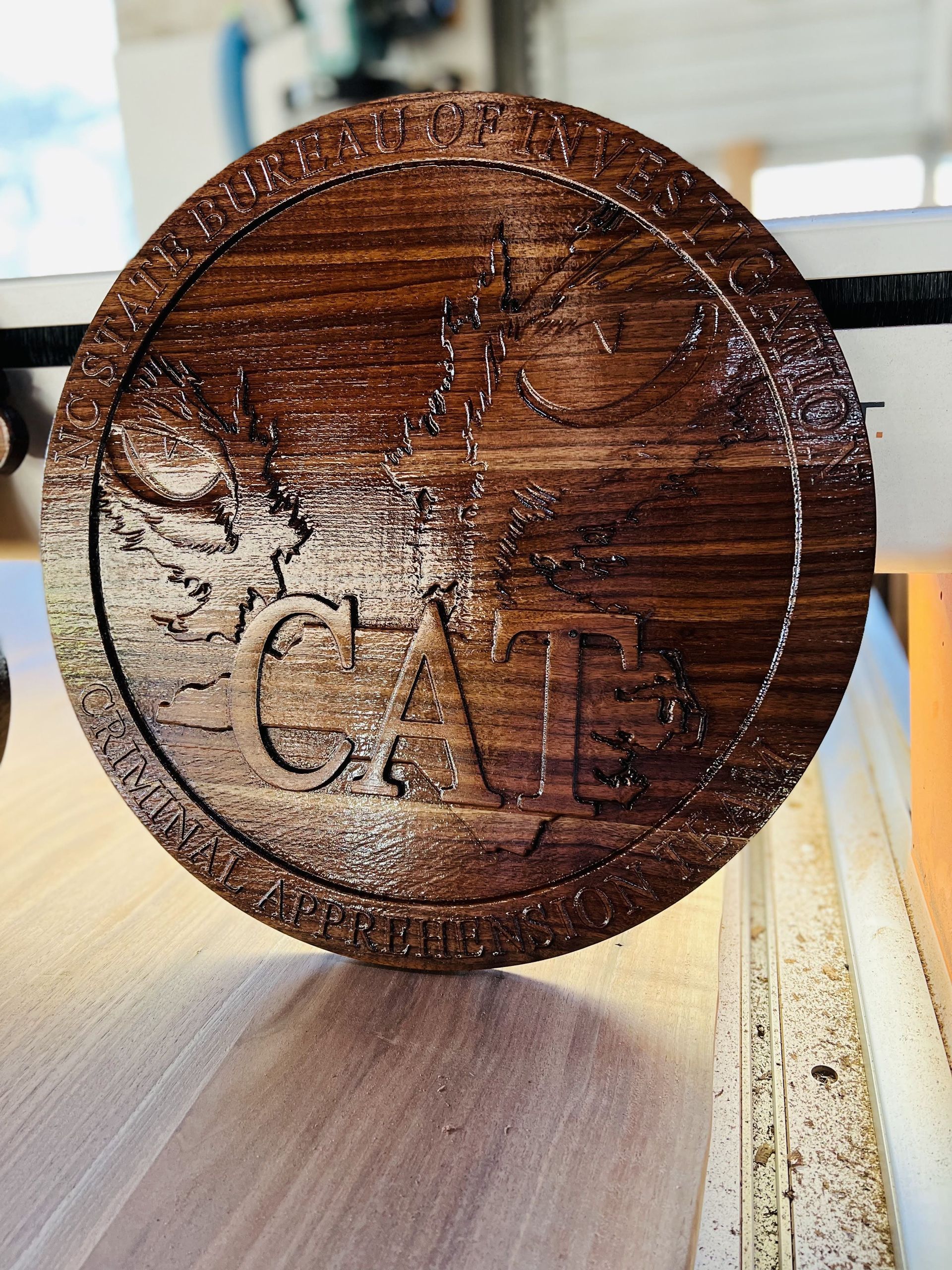 A wooden coin with the word cab carved into it