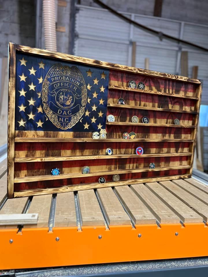 A wooden american flag is sitting on top of a wooden table.
