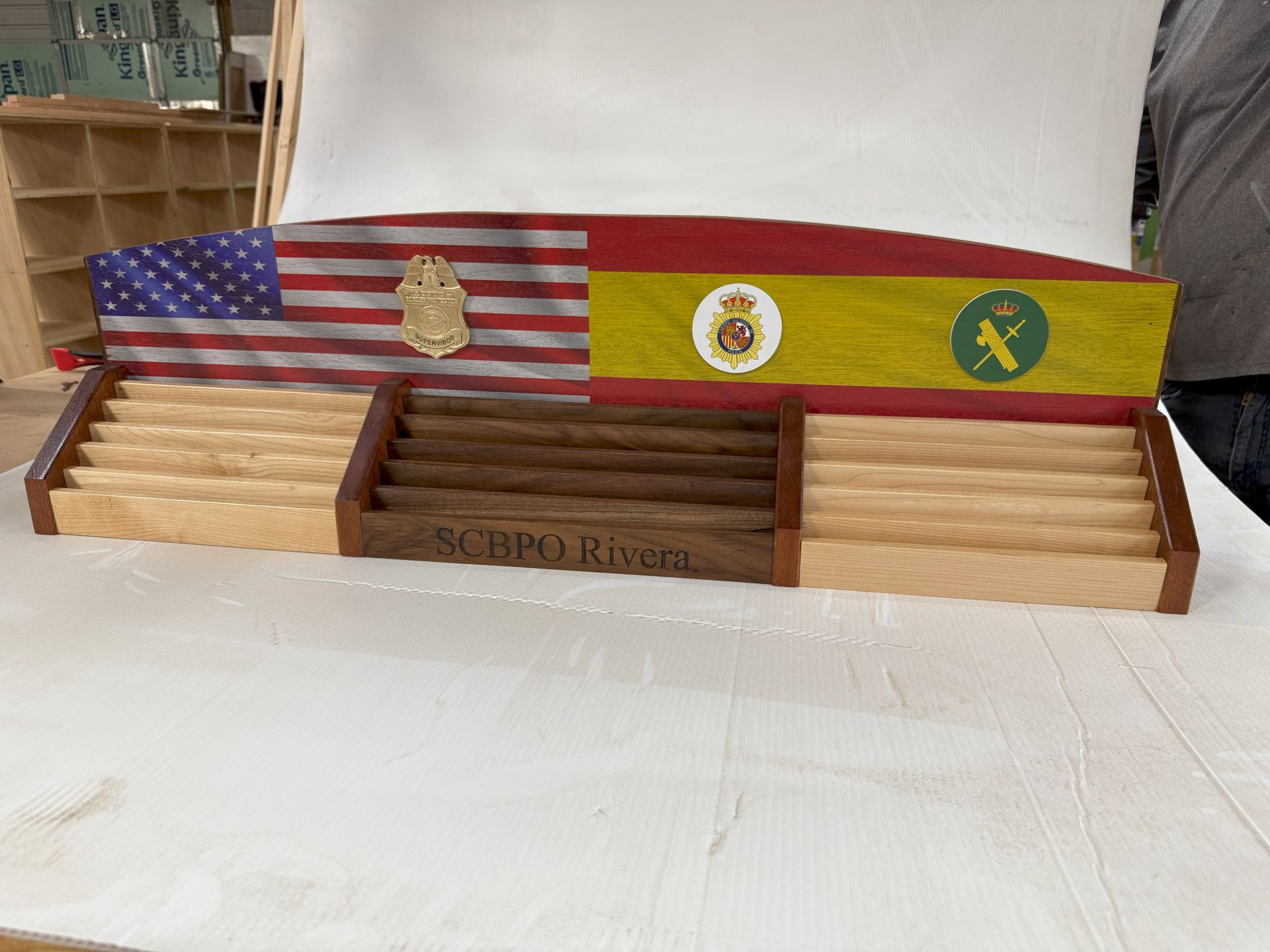 Wooden display with U.S. and Brazilian flags and military insignia on a stand