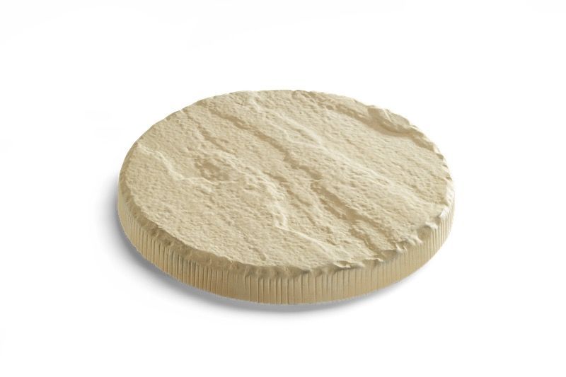 Round of light-colored, textured cheese.