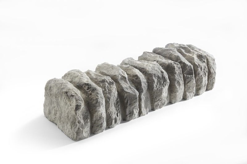 Stone edging, rectangular shape with rough, gray texture.